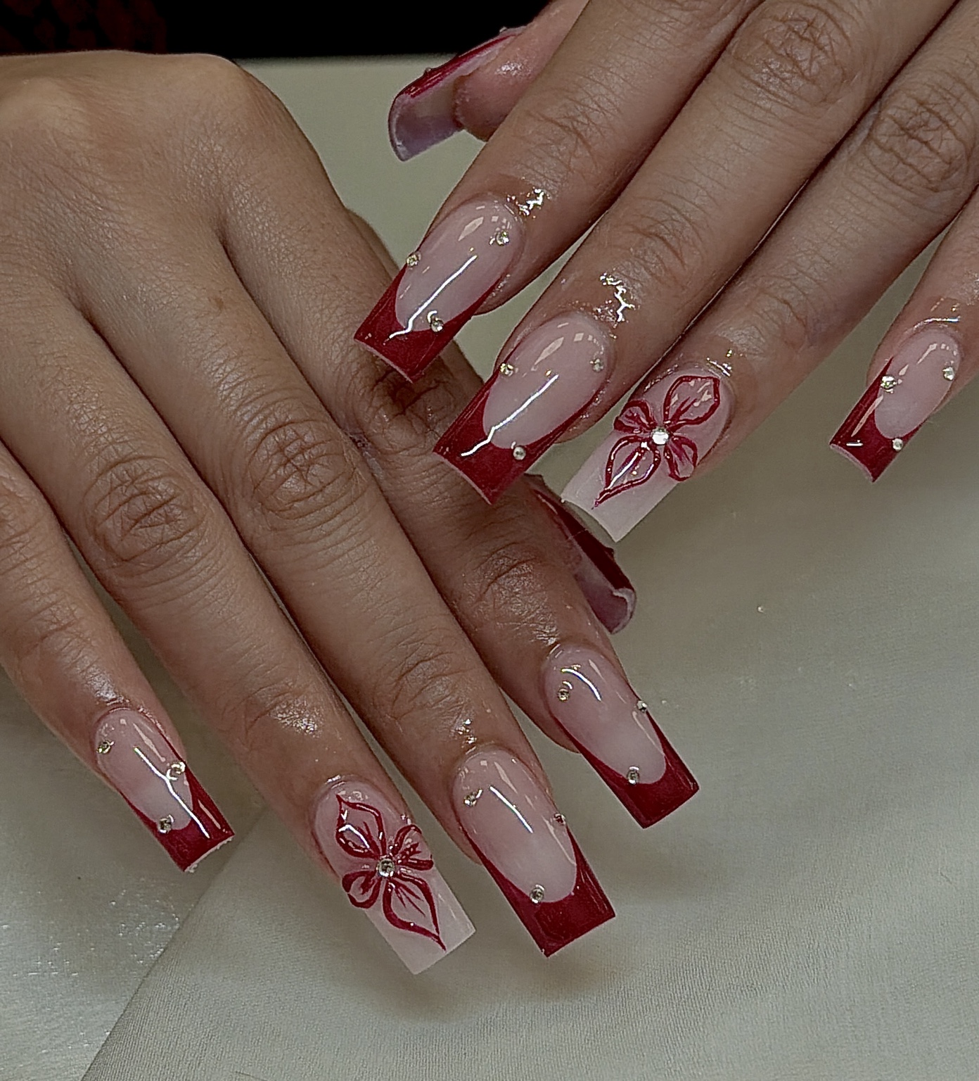 Red French tips with flowers and gold details